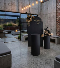 Load image into Gallery viewer, Black arch backdrop, 2 x black & gold flowers & 2 x black plinths - HIRE ONLY