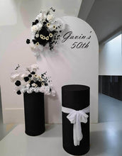 Load image into Gallery viewer, White arch backdrop, 2 x black & white flowers, 2 x black cylinder plinths - HIRE ONLY