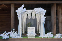 Load image into Gallery viewer, White wooden arbour & flowers w macrame - Deluxe Special - HIRE ONLY