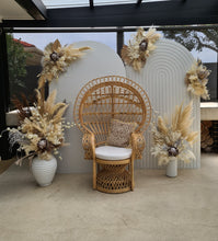 Load image into Gallery viewer, Two white backdrops / arches &amp; 5 x boho flowers &amp; Queen Peacock chair - HIRE ONLY
