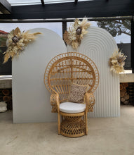 Load image into Gallery viewer, Two white backdrops / arches &amp; 3 x boho flowers &amp; Queen Peacock chair - HIRE ONLY
