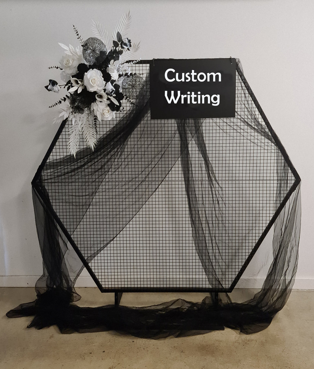 Black hexagonal backdrop & flowers - HIRE ONLY