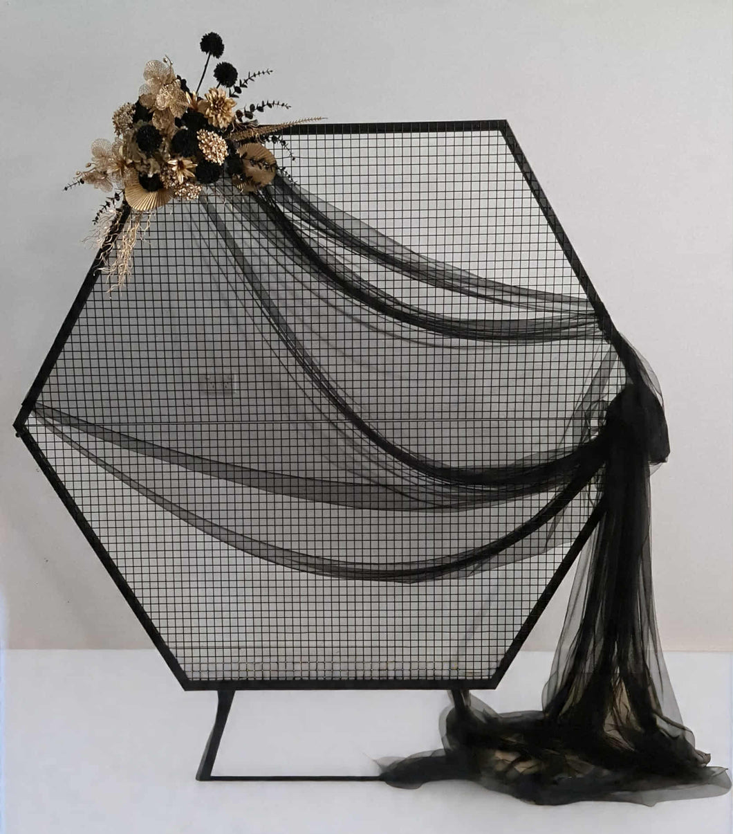 Black Hexagonal mesh backdrop and black & gold flowers - HIRE ONLY