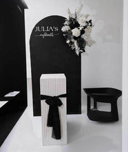Load image into Gallery viewer, Black arch backdrop, Black &amp; white flowers and white square ripple plinth / cake stand - HIRE ONLY

