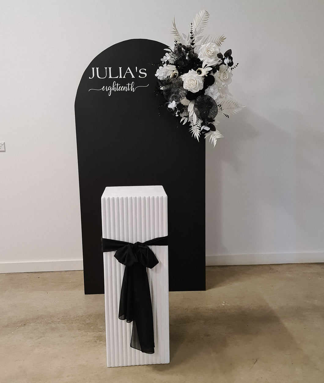 Black arch backdrop, Black & white flowers and white square ripple plinth / cake stand - HIRE ONLY