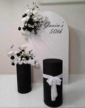 Load image into Gallery viewer, White arch backdrop, 2 x black &amp; white flowers, 2 x black cylinder plinths - HIRE ONLY
