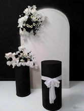 Load image into Gallery viewer, White arch backdrop, 2 x black &amp; white flowers, 2 x black cylinder plinths - HIRE ONLY

