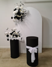 Load image into Gallery viewer, White arch backdrop, 2 x black &amp; white flowers, 2 x black cylinder plinths - HIRE ONLY
