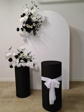 Load image into Gallery viewer, White arch backdrop, 2 x black &amp; white flowers, 2 x black cylinder plinths - HIRE ONLY
