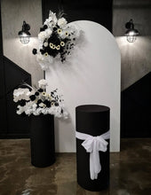 Load image into Gallery viewer, White arch backdrop, 2 x black &amp; white flowers, 2 x black cylinder plinths - HIRE ONLY
