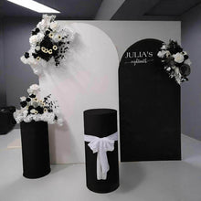 Load image into Gallery viewer, 2 x arch backdrop (black &amp; white), 3 x black &amp; white flowers, 2 x cylinder plinths - HIRE ONLY
