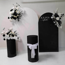 Load image into Gallery viewer, 2 x arch backdrop (black &amp; white), 3 x black &amp; white flowers, 2 x cylinder plinths - HIRE ONLY
