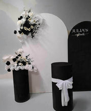 Load image into Gallery viewer, 2 x arch backdrop (black &amp; white), 3 x black &amp; white flowers, 2 x cylinder plinths - HIRE ONLY
