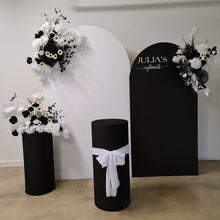 Load image into Gallery viewer, 2 x arch backdrop (black &amp; white), 3 x black &amp; white flowers, 2 x cylinder plinths - HIRE ONLY
