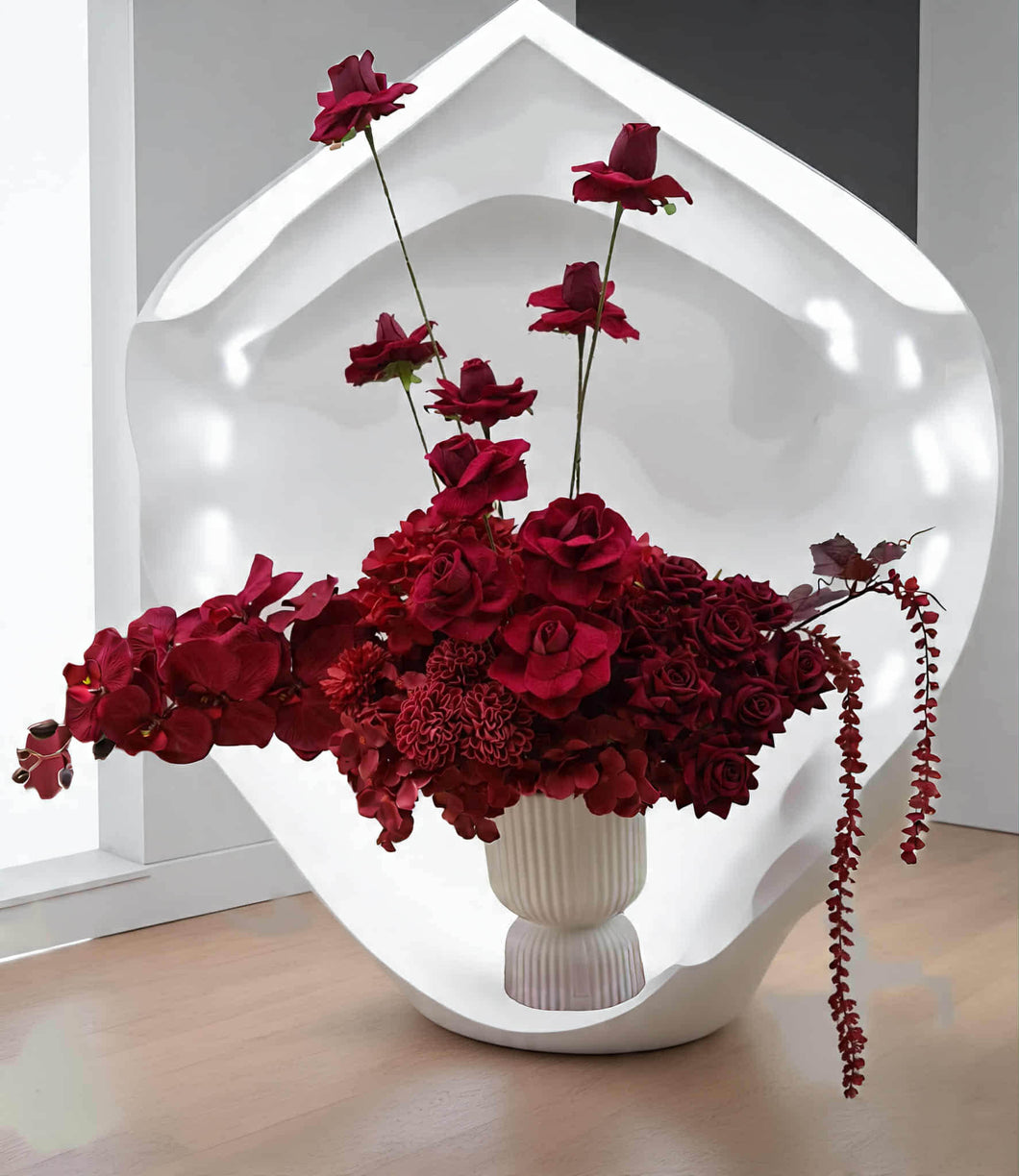 Burgundy floor / plinth flowers in white ribbed pot - HIRE OLY