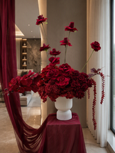 Load image into Gallery viewer, Burgundy floor / plinth flowers in white ribbed pot - HIRE OLY
