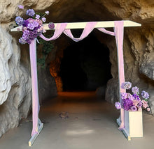 Load image into Gallery viewer, White wood arbour &amp; 2 x purple / violet flowers - HIRE ONLY
