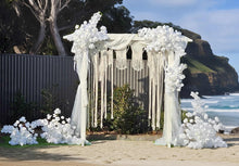 Load image into Gallery viewer, White wooden arbour &amp; flowers w macrame - Deluxe - HIRE ONLY
