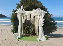Load image into Gallery viewer, White wooden arbour &amp; flowers w macrame - Deluxe - HIRE ONLY
