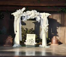 Load image into Gallery viewer, White wooden arbour &amp; flowers w macrame - Deluxe Special - HIRE ONLY
