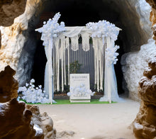 Load image into Gallery viewer, White wooden arbour &amp; flowers w macrame - Deluxe Special - HIRE ONLY
