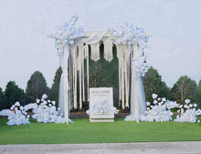 Load image into Gallery viewer, White wooden arbour &amp; flowers w macrame - Deluxe Special - HIRE ONLY
